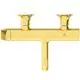 Goldene Badearmatur mit zwei Wasserhähnen und einem zentralen Auslauf, designed von Ideal Standard. Klare, geometrische Formgebung ohne sichtbare Bedienelemente.